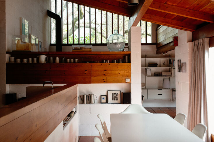 Modernist living room with wood-paneled ceilings and high clerestory windows.