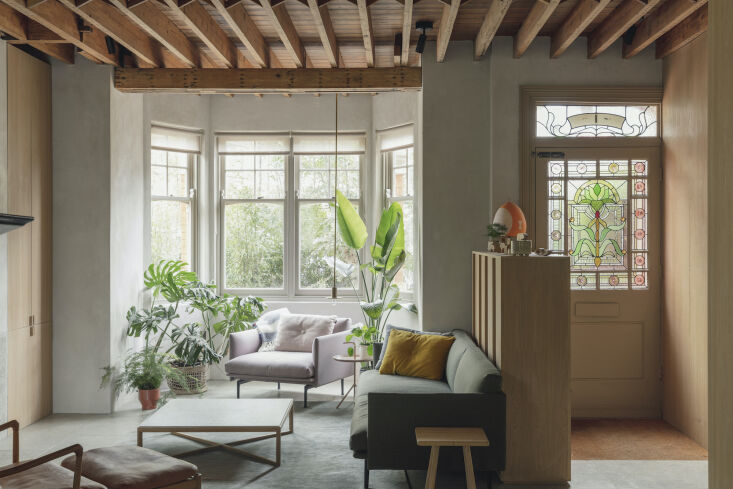 Restored Edwardian stained glass front door and exposed wooden ceiling joists.