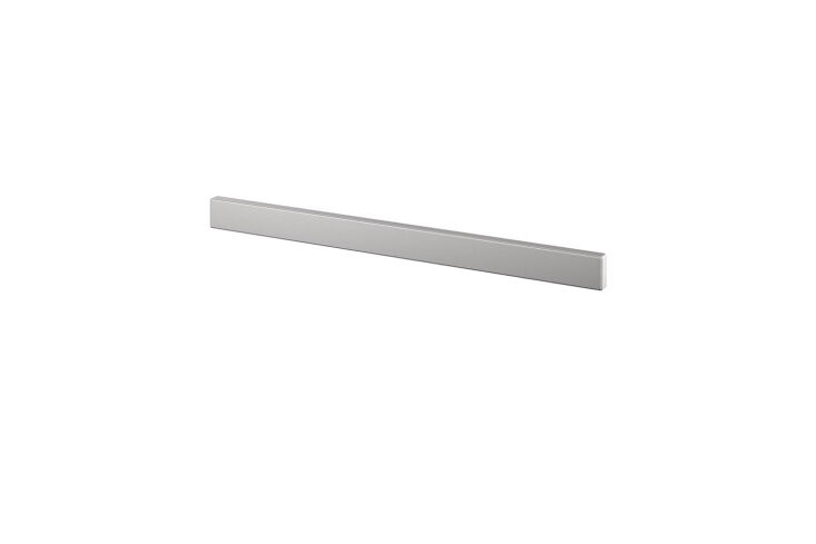 A sleek stainless steel magnetic knife rack mounted on a kitchen wall.