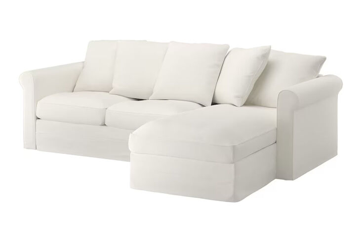 A white IKEA Härlanda sectional sofa in a bright, sunlit living room.