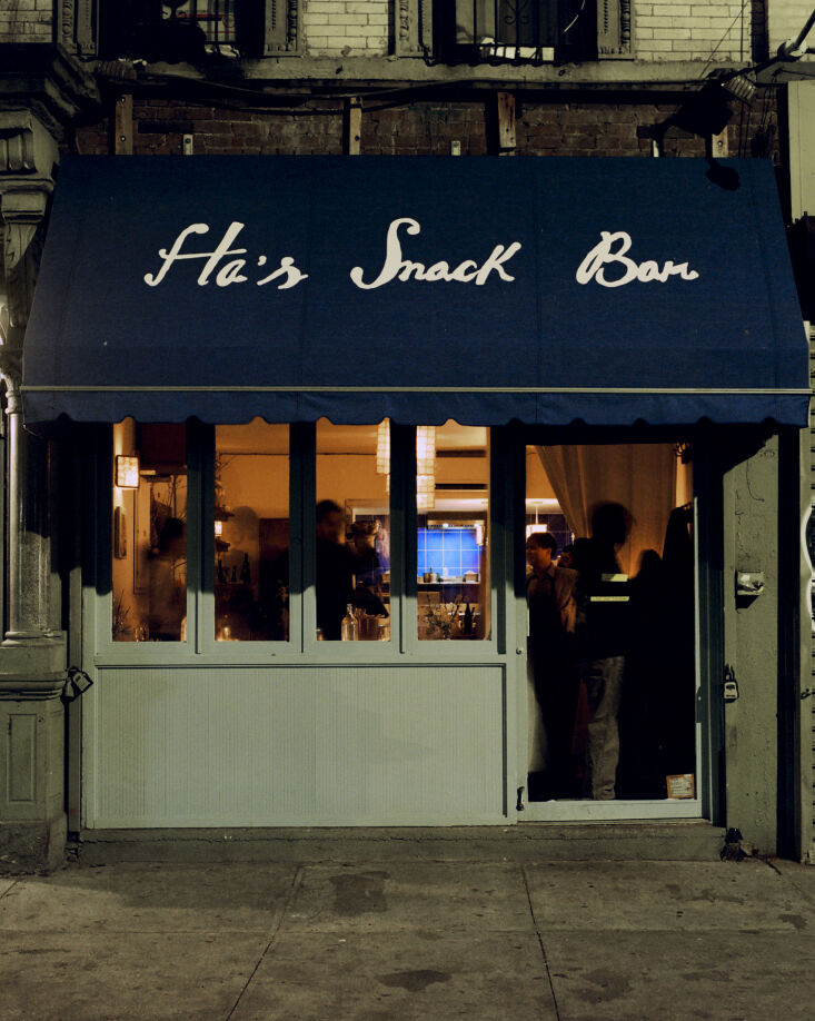 The restaurant filled with customers during the evening, glowing with warm light.