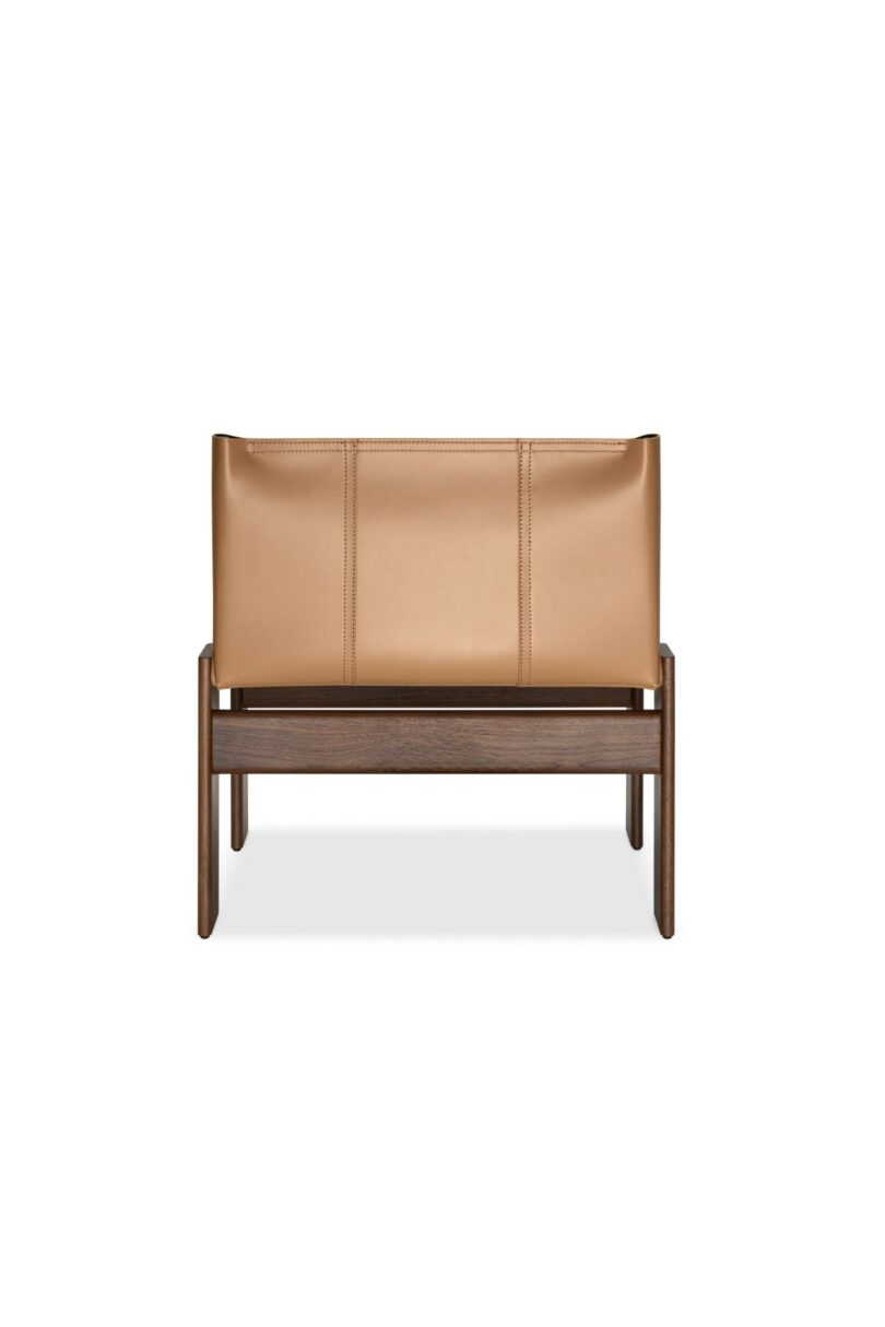 Side profile of the Monk armchair with tan leather and a dark wood frame.