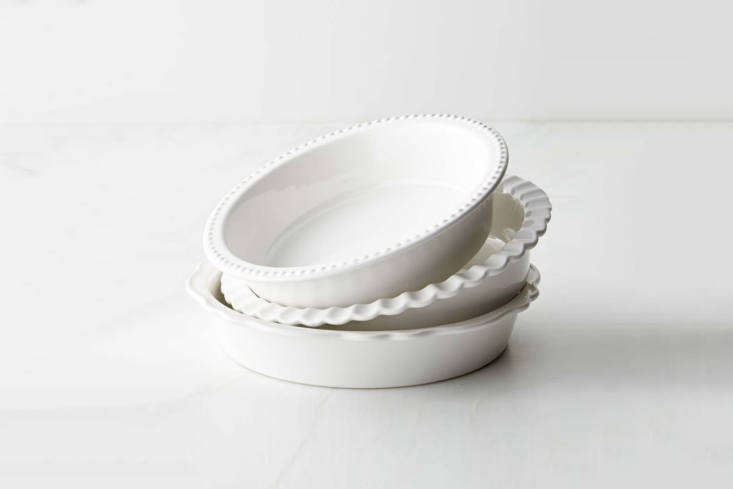 A set of three vintage-style stoneware pie dishes in varying sizes.