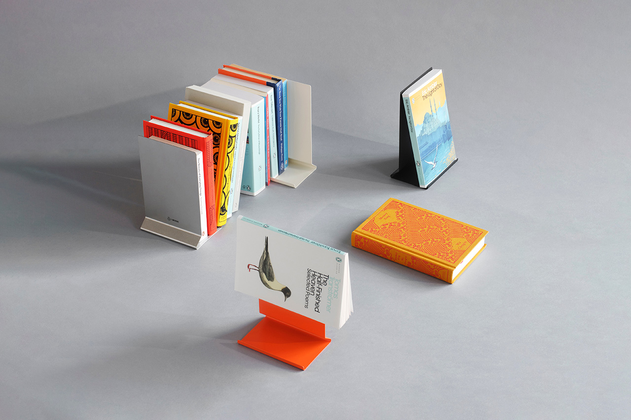 The Penguin x MOEBE Book Stand holding a book open on a flat surface.