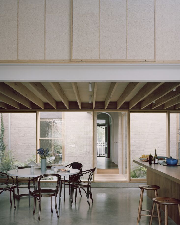 An elevated wooden breezeway connecting the original historic cottage to the modern rear addition.