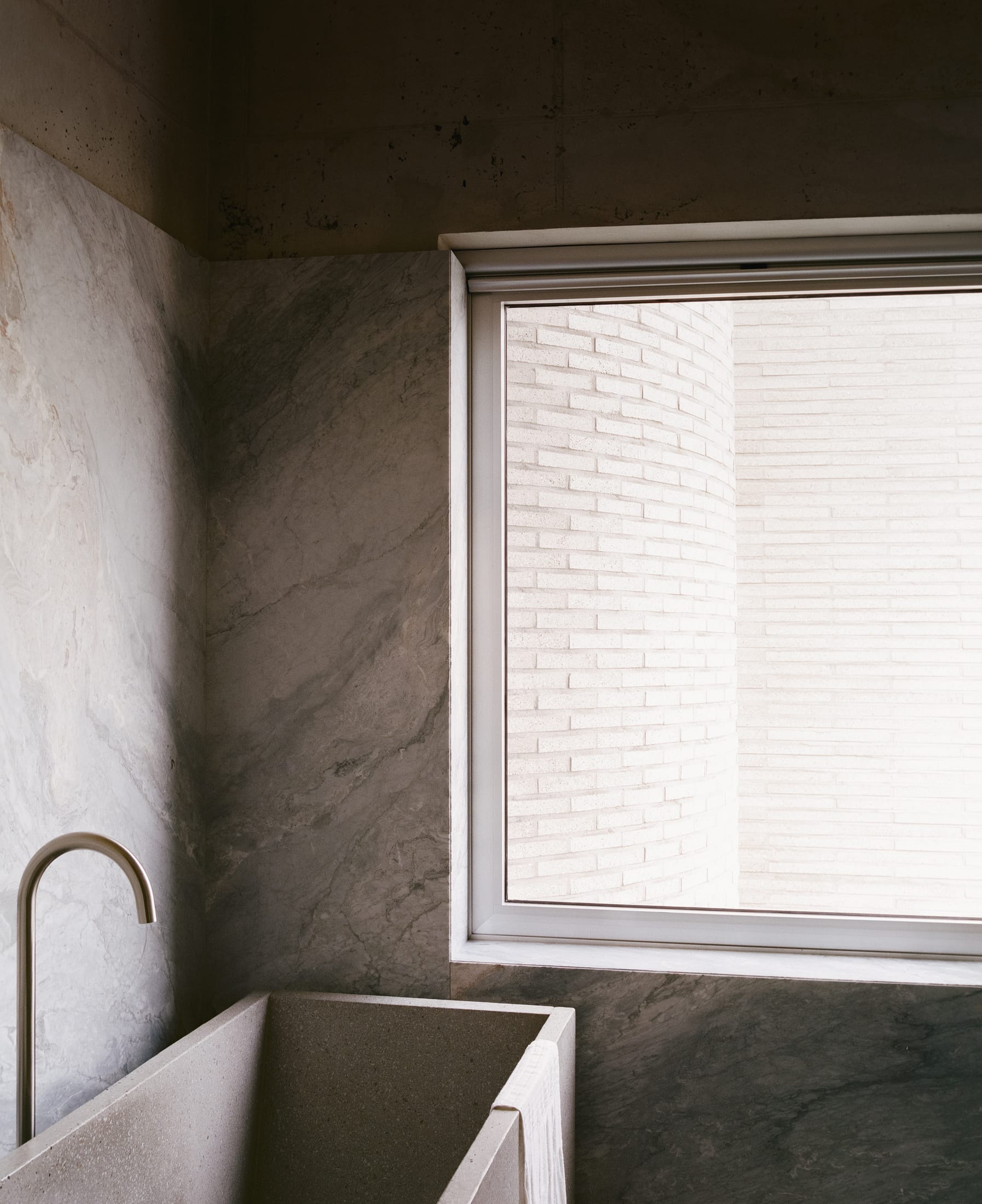 A minimalist, curved white staircase landing that minimizes dead space.