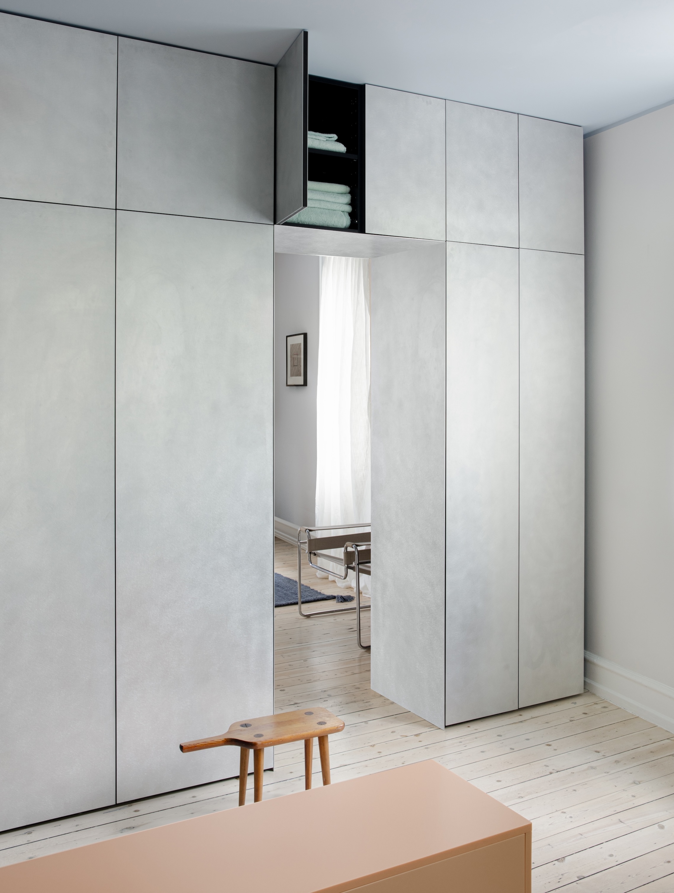 A wardrobe featuring hand-brushed aluminum fronts from the Plate line by David Thulstrup.