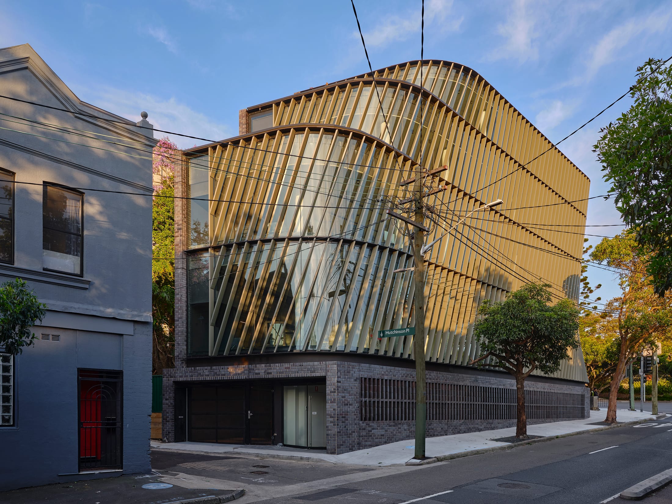 Close-up of the vertical zinc fins on the building's facade, showing their angled orientation for solar control.