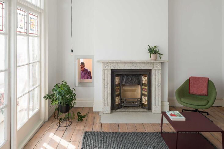A small square hatch between the living room fireplace and the kitchen allowing for conversation and food passage.