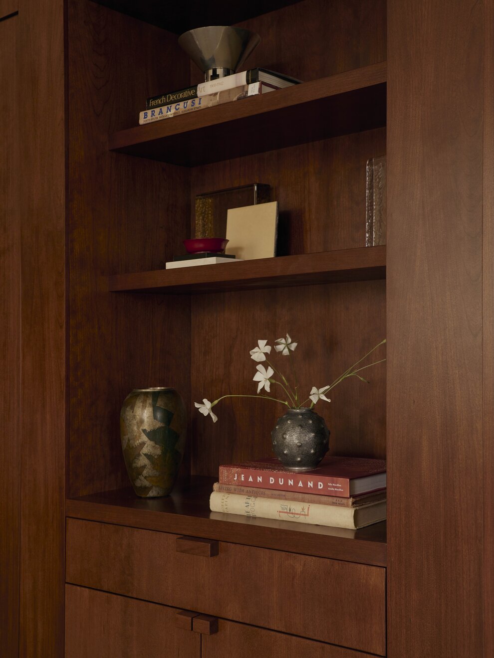 A bright, airy view of the main studio space in The Atelier with neutral tones and sculptural furniture.