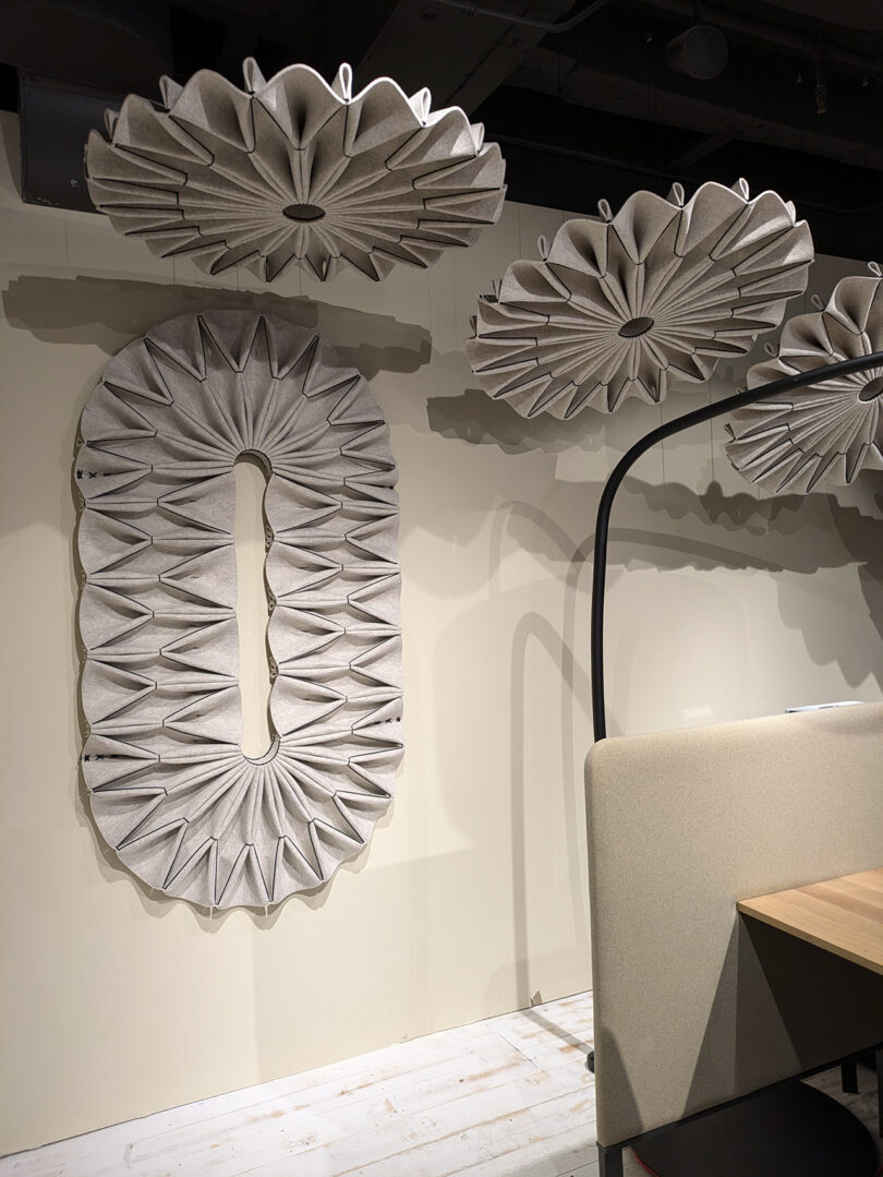 Wall and ceiling-mounted acoustic panels with a textured, pleated design in a modern interior.