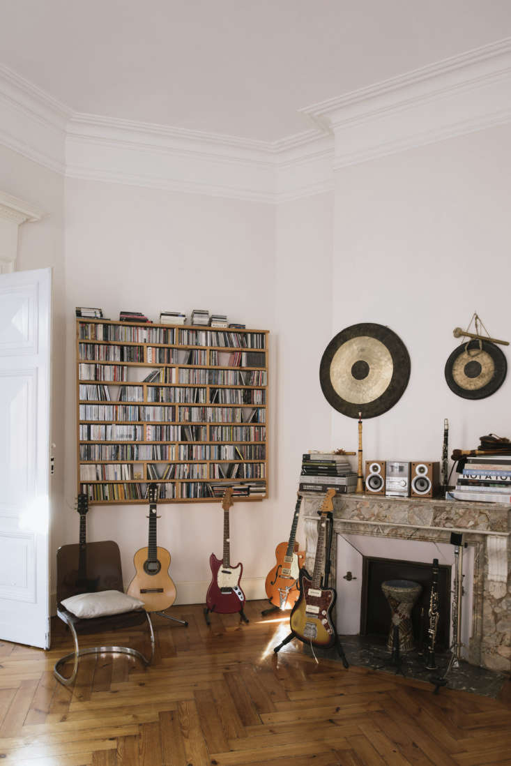 Full wall of CDs neatly organized in a bright, modern living space.
