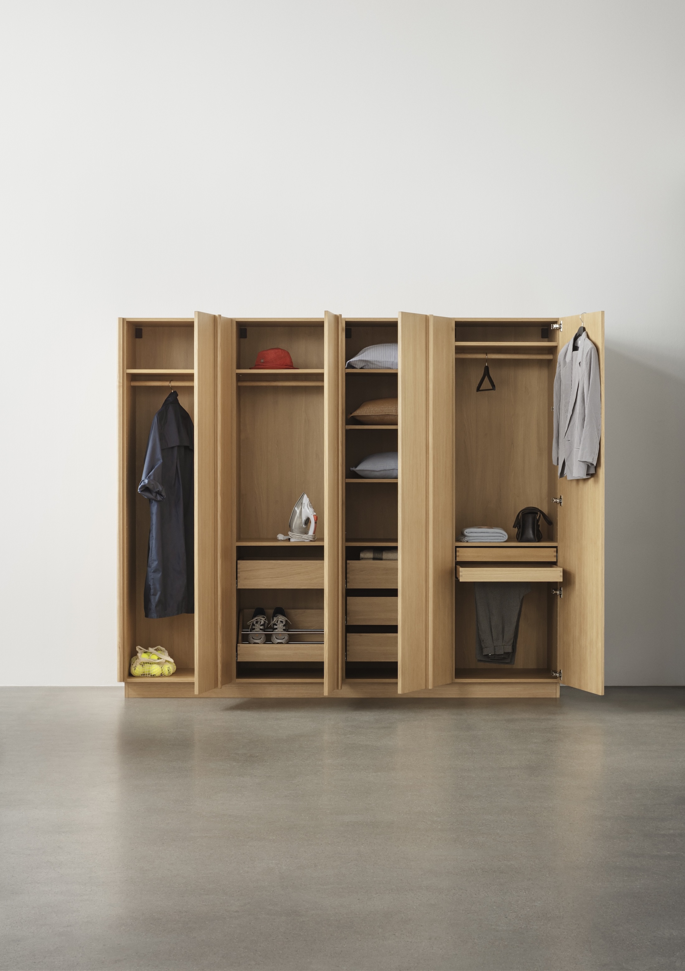 Internal view of a modular wardrobe showing divided drawers and shoe shelves.