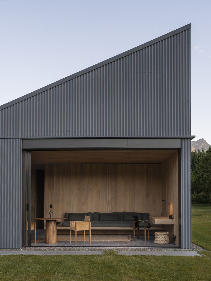 View through a hallway showing the transition between shared communal spaces and private bedroom wings.