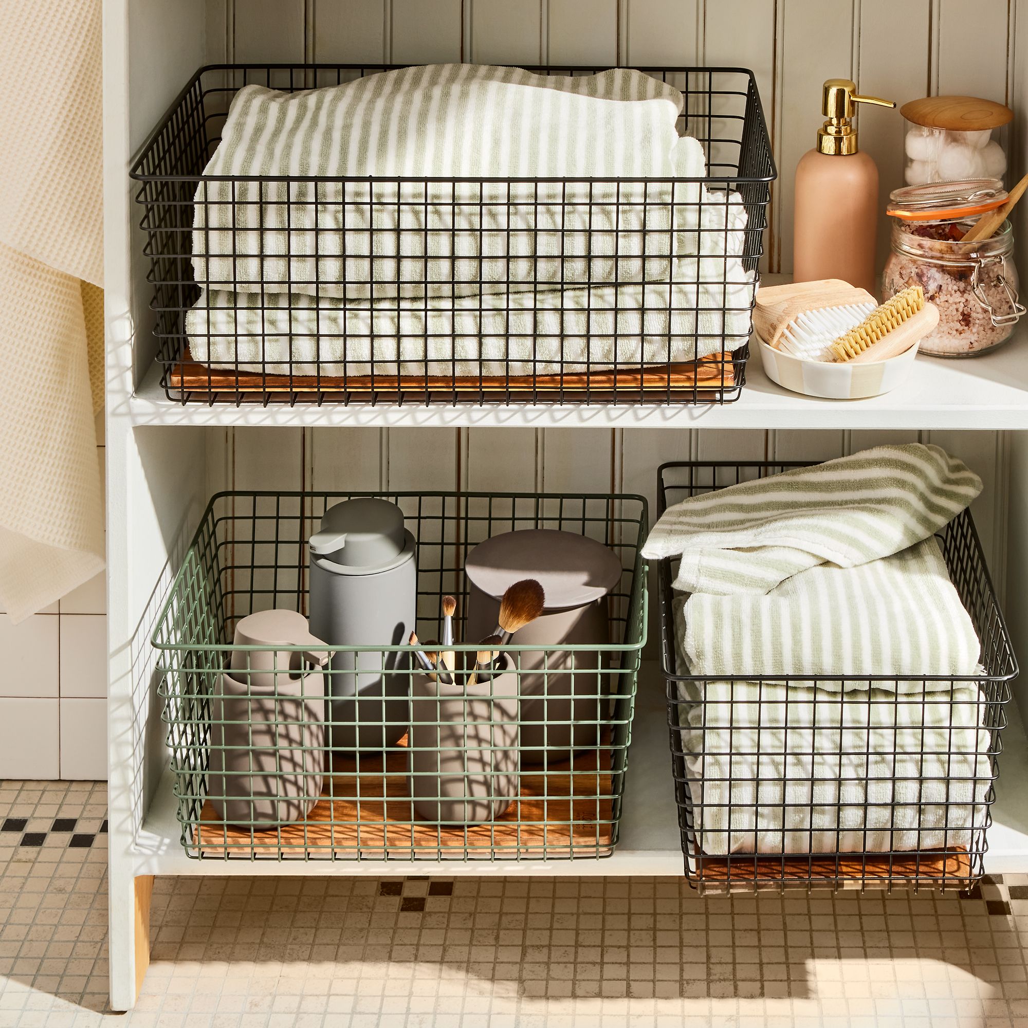 Graphic listing space-saving tricks for small bathrooms including vertical shelving and rolling carts.