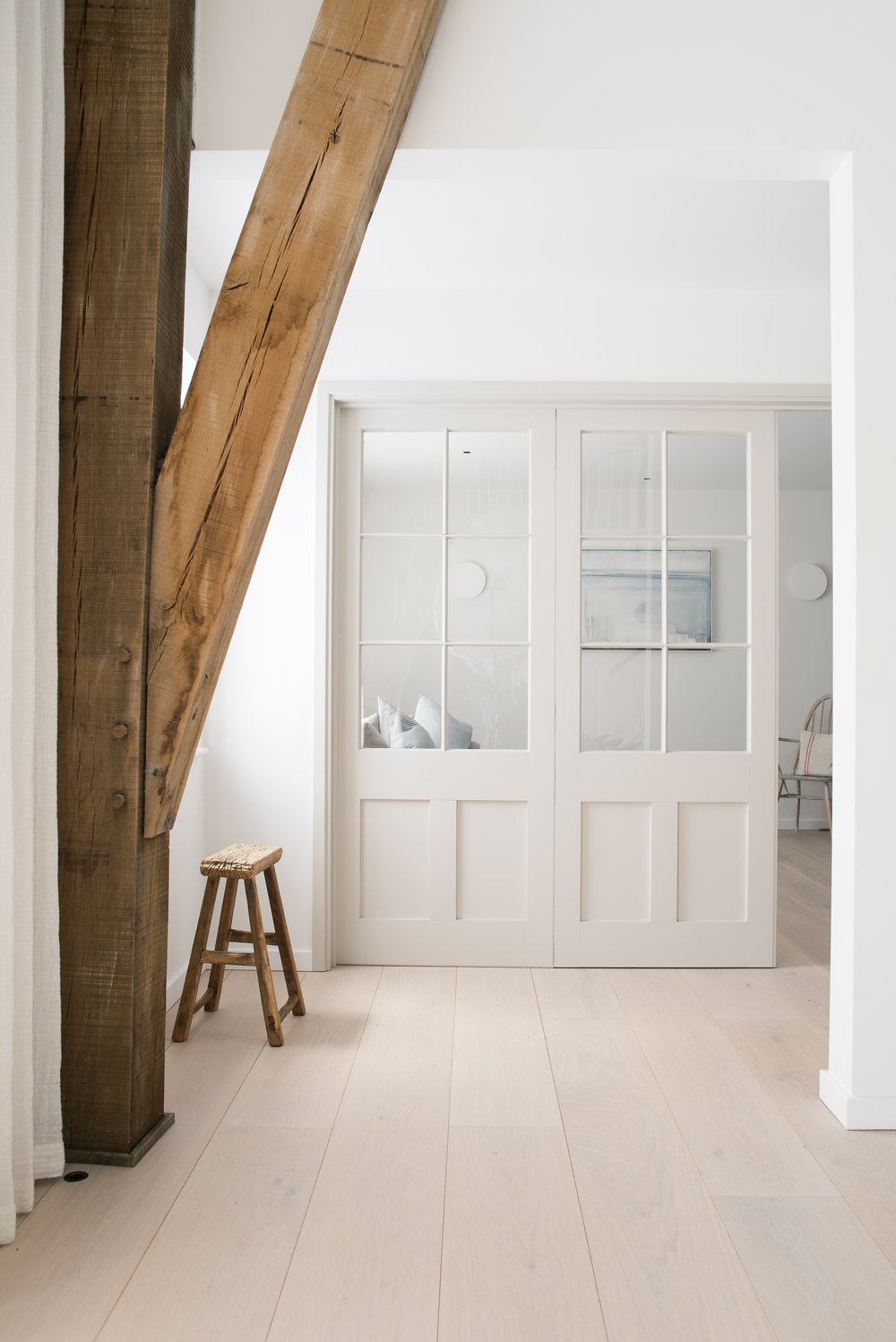 A cozy 'snug' room with lime-painted walls and a circular wall light, doubling as a guest space.