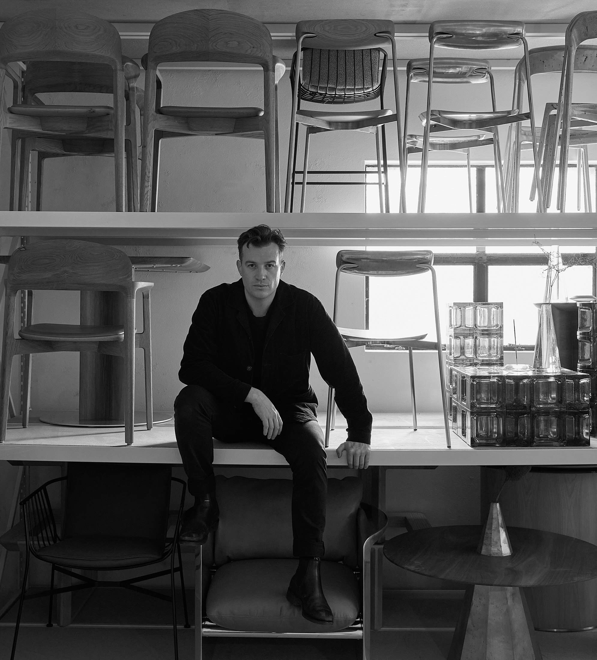 A portrait of designer Tom Fereday standing in his Sydney studio environment.