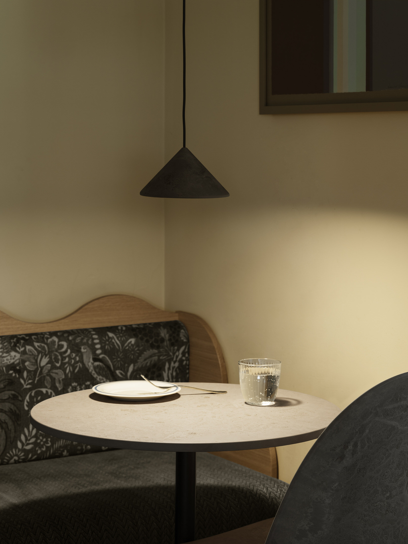 Mater Terra table lamp placed on a minimalist wooden side table against a neutral wall.