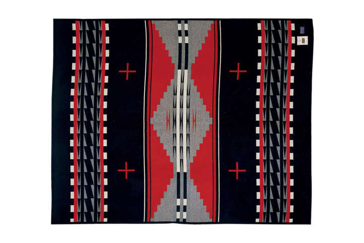 A Pendleton Earth Blanket with a black multi-colored geometric pattern.