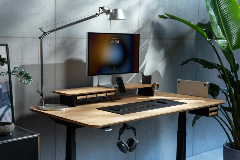 A wide, well-lit shot of a modern workspace featuring a large monitor and Balolo accessories.