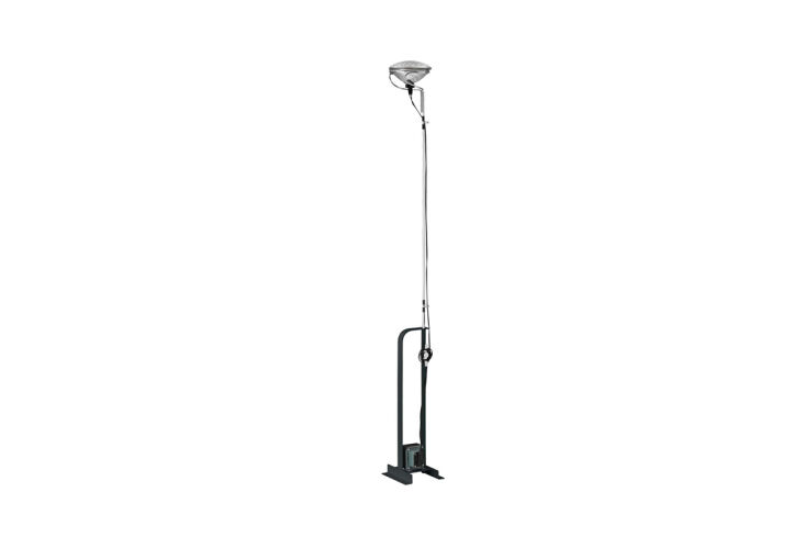A Flos Toio LED Lamp with a metal base and exposed cord against a minimalist wall.