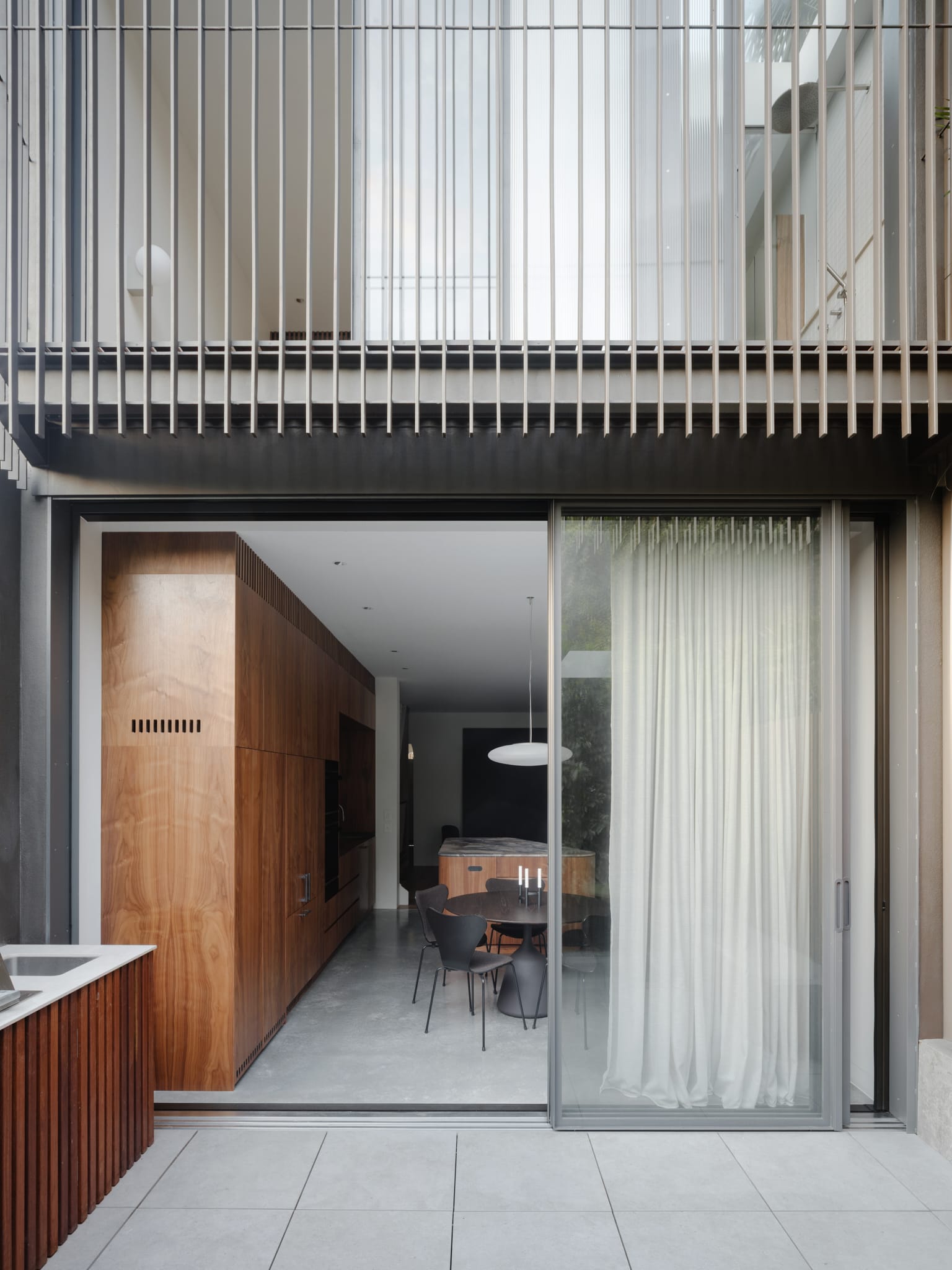 Street view of a narrow, modern multi-level residence in Surry Hills.