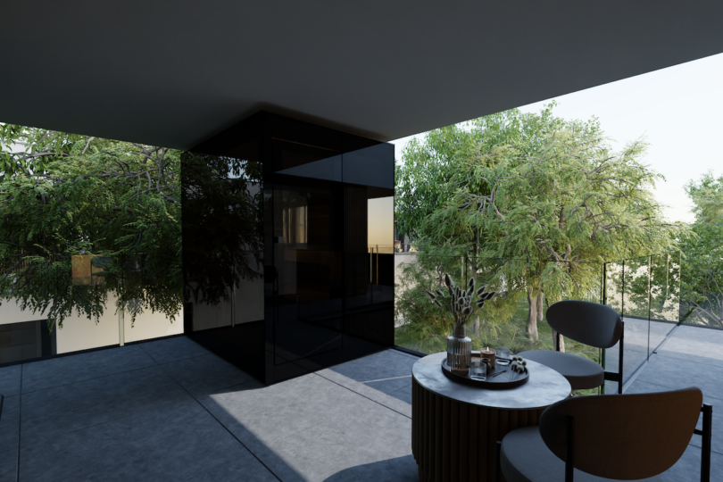 A modern balcony with glass railings and a small table set for relaxation with a view of trees.