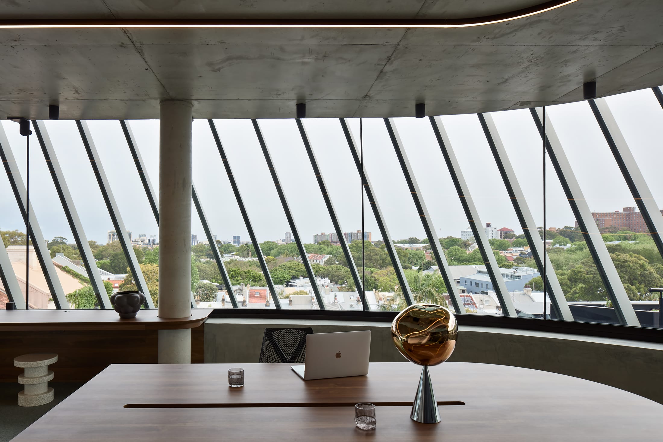 Open-plan office area with warm overhead lighting and flexible desk arrangements.