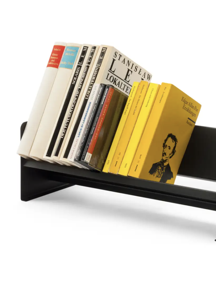 A small steel desktop rack holding a handful of CDs.