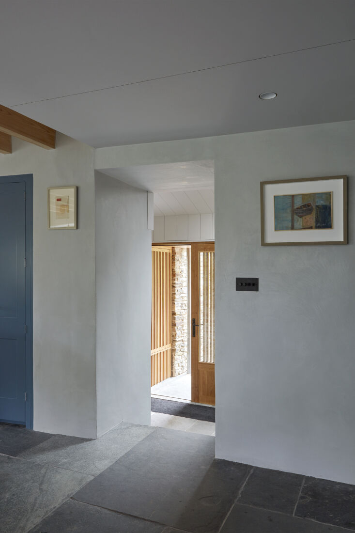 Interior view showing a mix of plaster, slate, and wood materials used in the renovation.