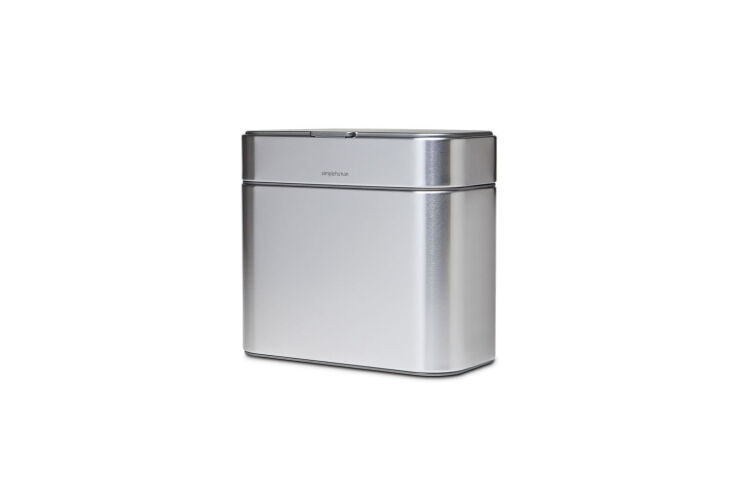 A compact stainless steel Simplehuman compost caddy designed for easy attachment and storage.