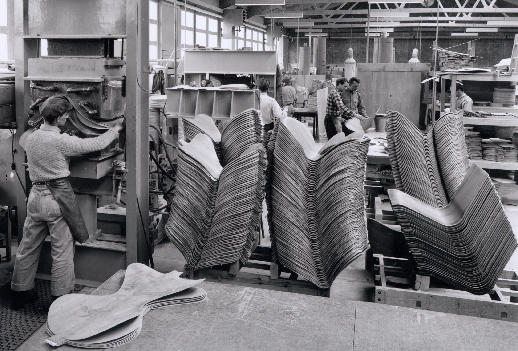 Black and white archival photo of Series 7 chairs in production from 1956.
