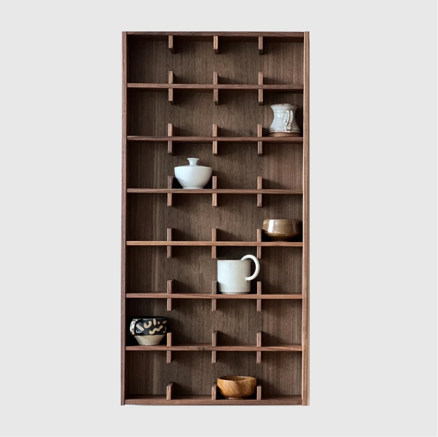 The large Sætter 7 wall shelf in dark walnut wood.