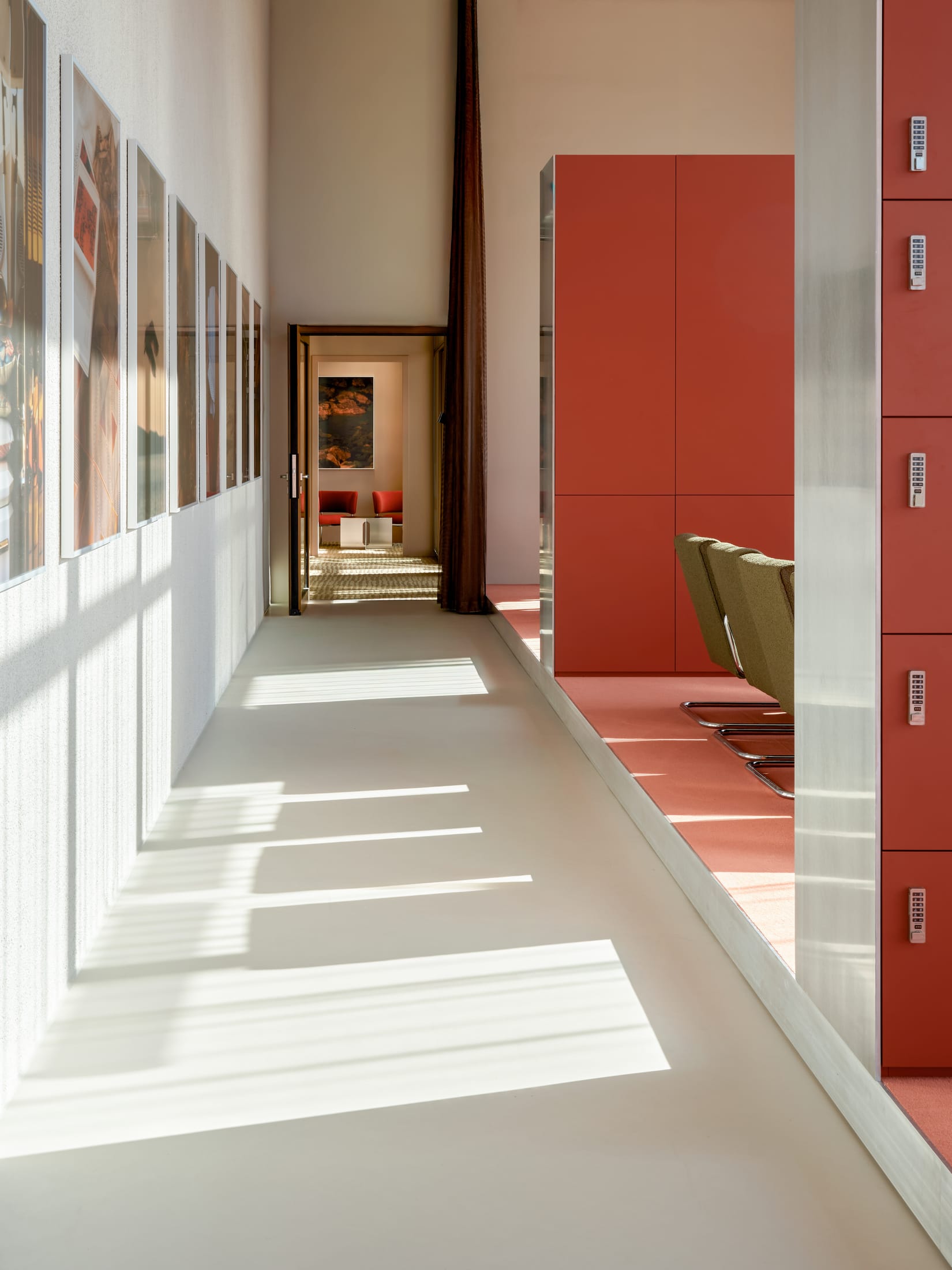 Industrial-style office interior with high ceilings and rhythmic structural columns.