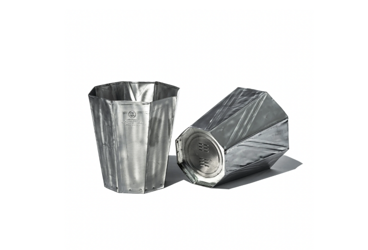 A pair of industrial-style recycled steel trash cans in round and hexagonal shapes.