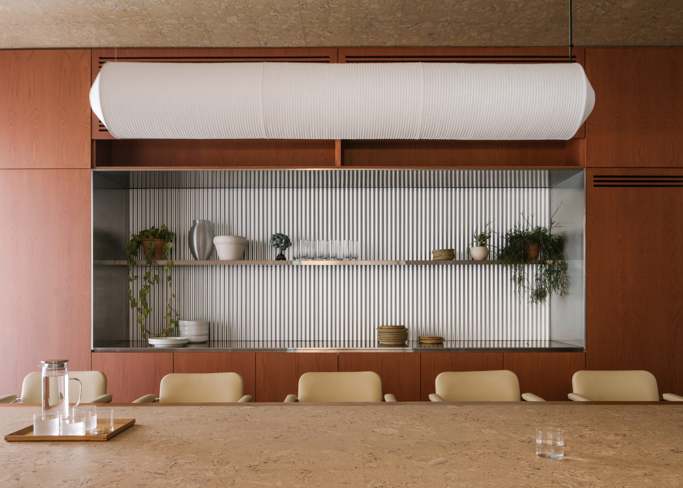 A quiet office corner featuring a plush area rug and soft upholstered seating.