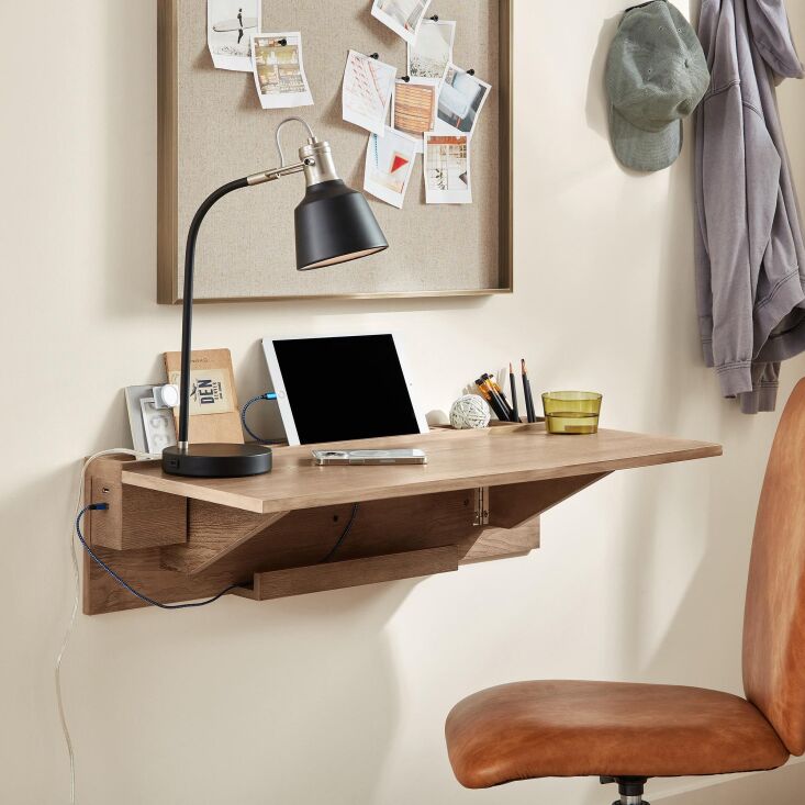 Wall-mounted white secretary desk with built-in USB ports and a tablet slot.