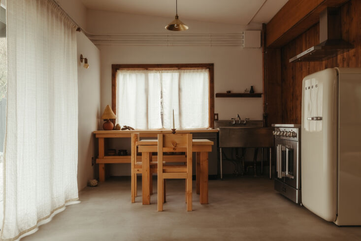 Kitchen area featuring reclaimed wood walls, counters, and shelving.
