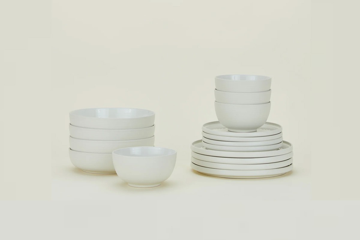Five different styles of high-quality dinnerware plates stacked together.
