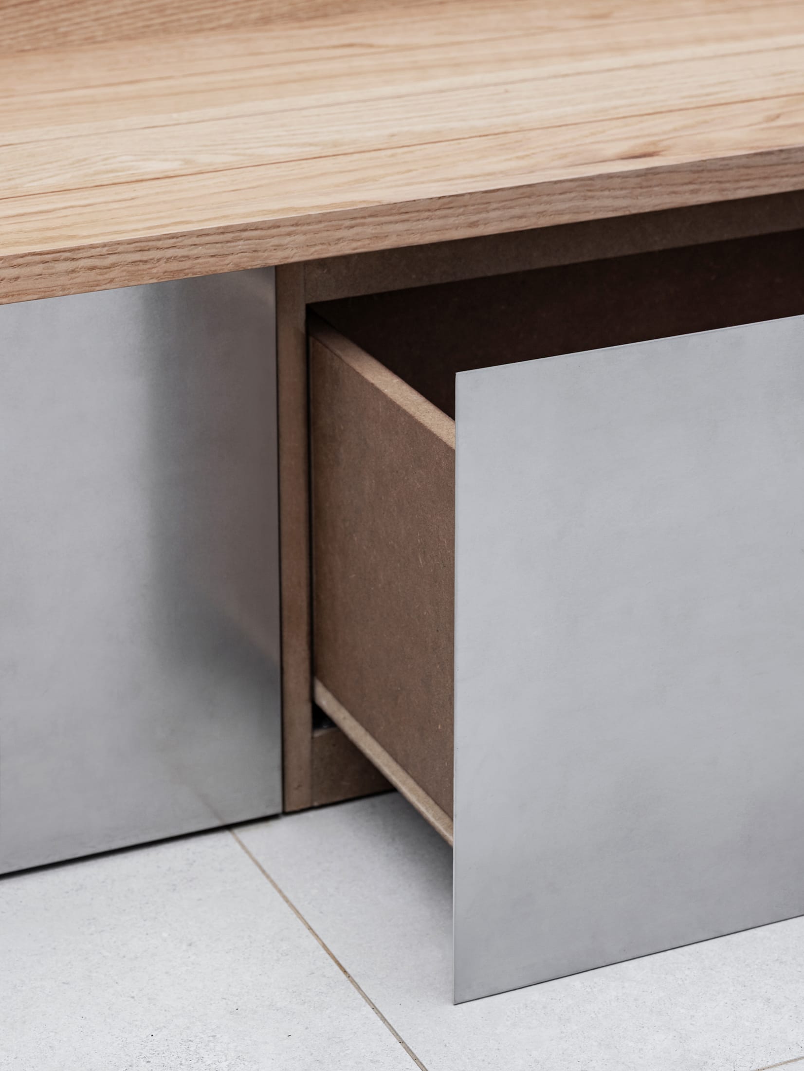 Close-up of the metal grid ceiling with integrated lighting fixtures.