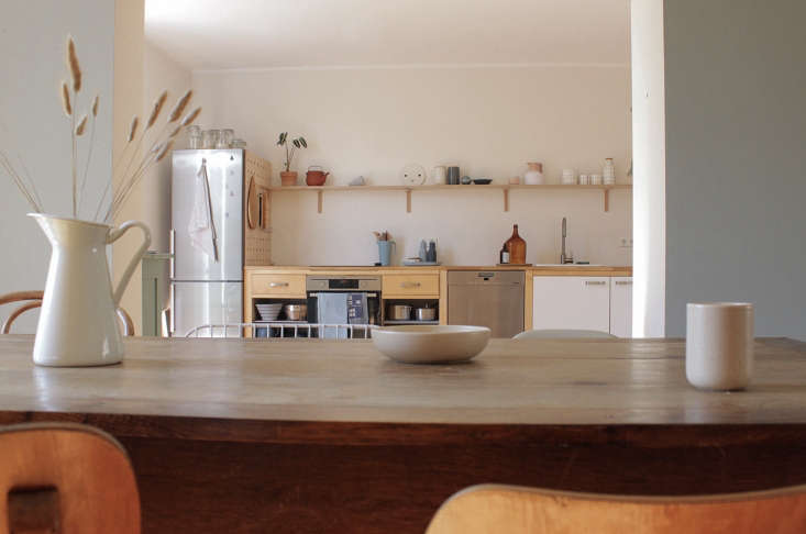IKEA Värde birch cabinets paired with a long, custom-made wooden open shelf for a modern, airy look.
