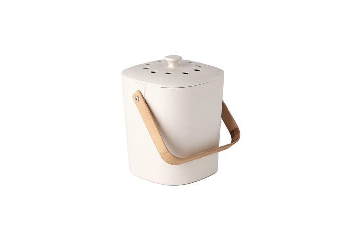 A pastel-colored countertop compost bin made from biodegradable bamboo fiber.