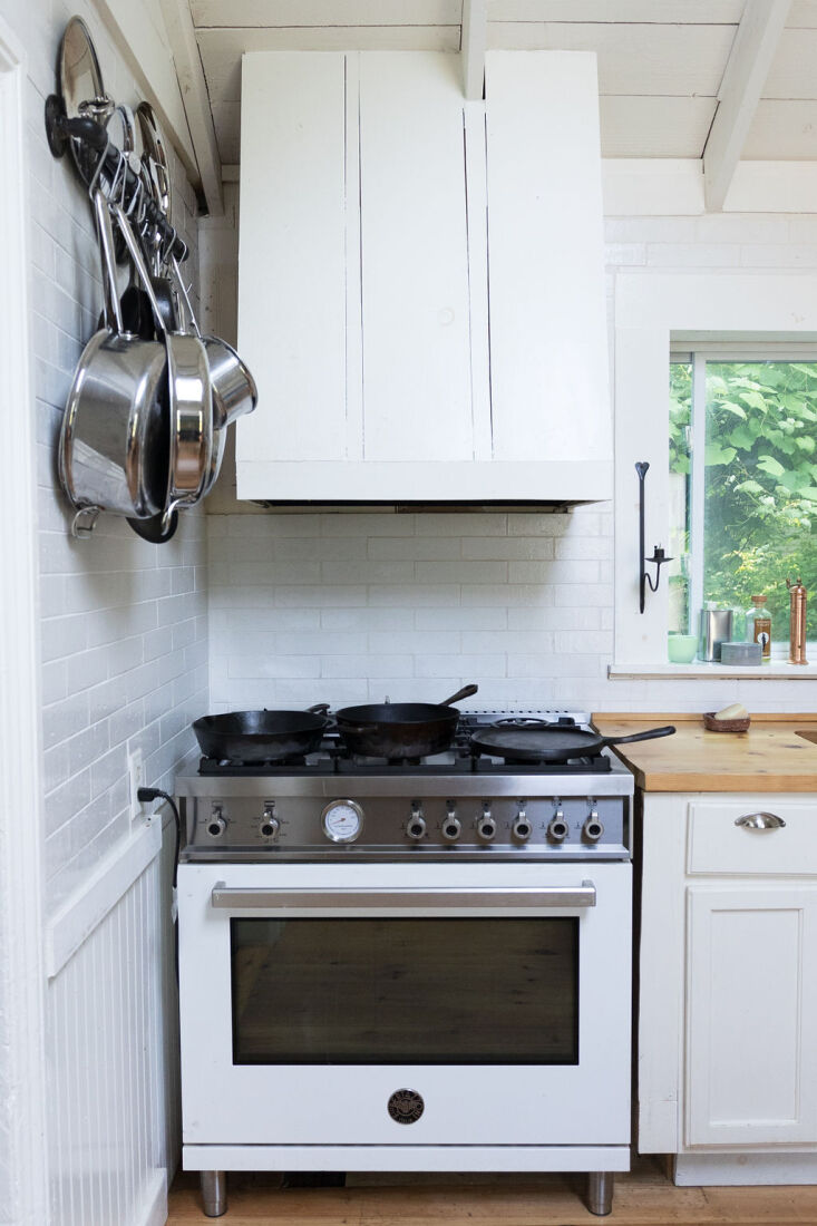 A stainless steel Bertazzoni stove integrated into a simple kitchen setup.
