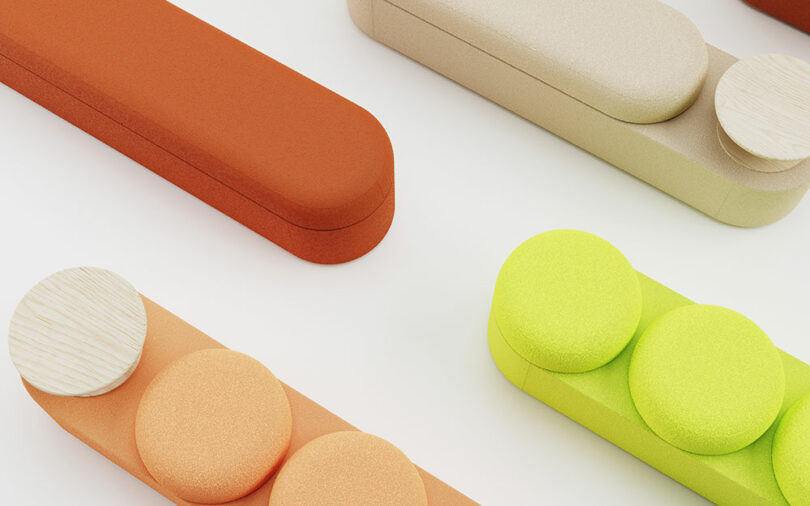 Abstract arrangement of furniture components in orange, green, and wood on a white surface.
