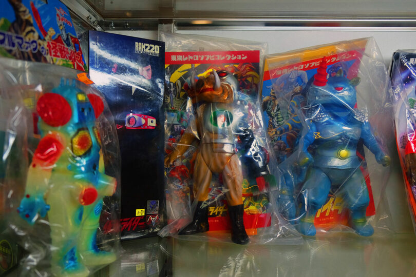 Vintage Japanese action figures in plastic packaging on a shelf.