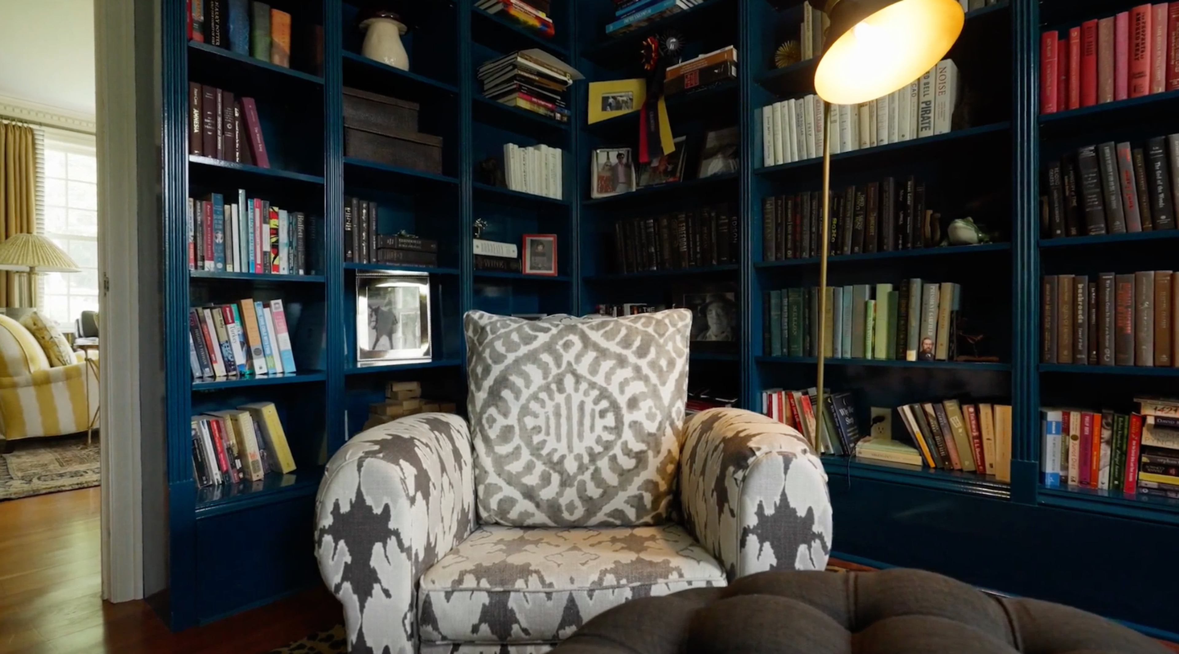 A cozy reading alcove with built-in bookshelves and a comfortable chair.