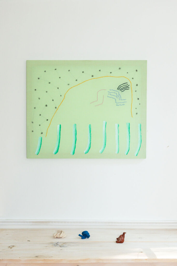 An abstract painting displayed on a simple wall in the living area.