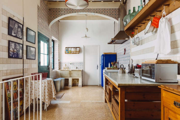A bright, spacious kitchen in the Sa Calma townhouse with high ceilings and historical architectural details.