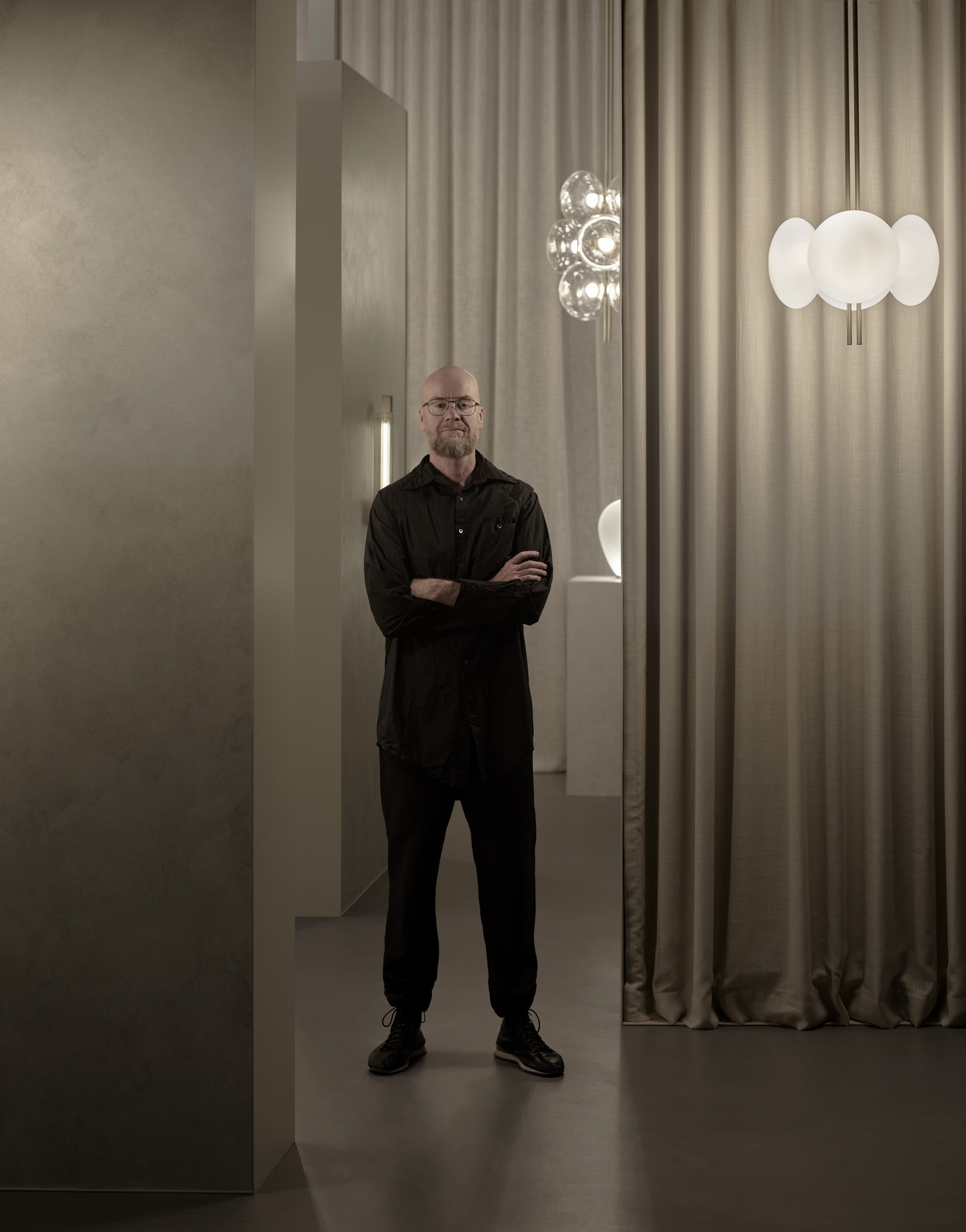 Dramatic lighting installation by Ross Gardam in a dark, historic Milanese interior.