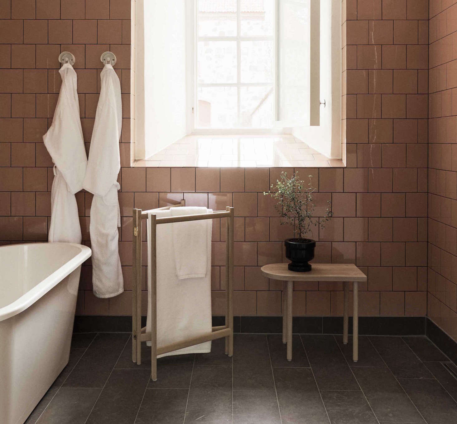 A small-scale folding towel rack used as a petite bathside accessory.